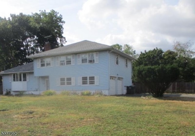 exterior space featuring a garage and a lawn