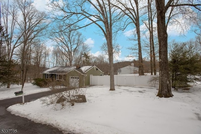 yard layered in snow with a garage