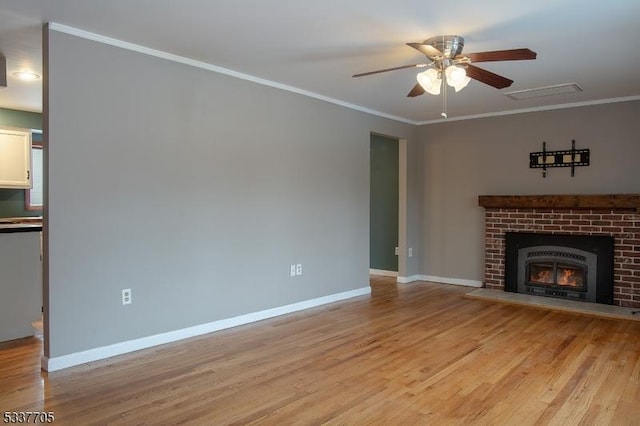 unfurnished living room with a brick fireplace, light hardwood / wood-style flooring, ornamental molding, and ceiling fan