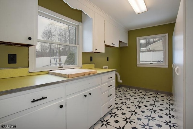 kitchen featuring ornamental molding and white cabinets