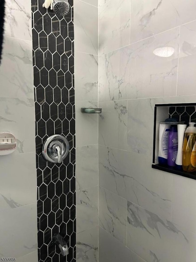 bathroom with tiled shower