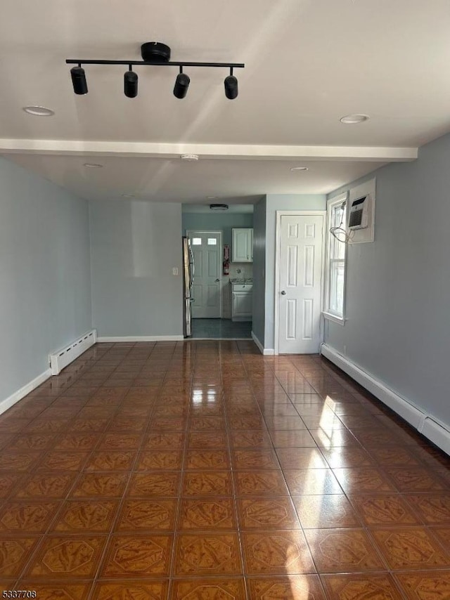 empty room with a wall unit AC and baseboard heating