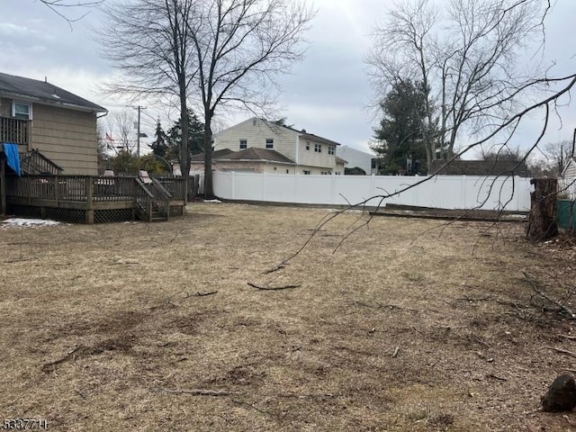 view of yard featuring a fenced backyard and a wooden deck