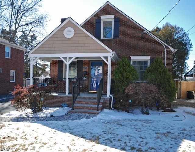 bungalow-style house with a porch and brick siding