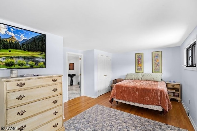 bedroom featuring baseboards and wood finished floors