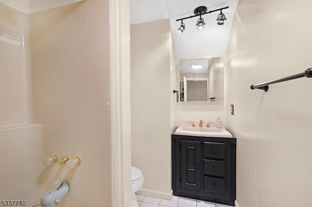 bathroom with tile patterned flooring, baseboards, vanity, and toilet