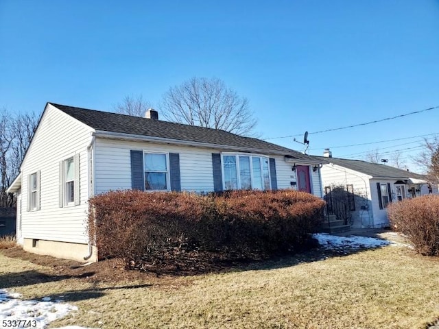 single story home with roof with shingles, a front lawn, and a chimney