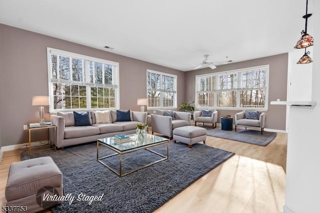 living room with hardwood / wood-style flooring and ceiling fan