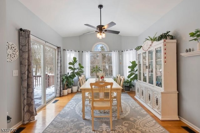 interior space with lofted ceiling, visible vents, and ceiling fan