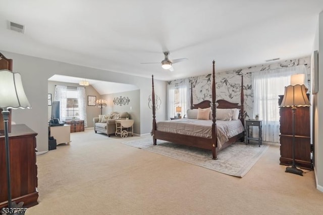 bedroom featuring light carpet, ceiling fan, visible vents, and vaulted ceiling