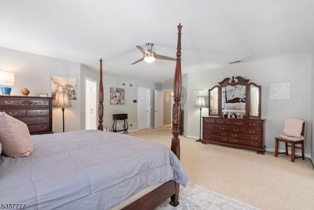 carpeted bedroom featuring baseboards, visible vents, and a ceiling fan