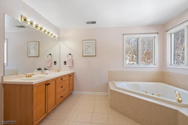 full bathroom with double vanity, visible vents, tile patterned floors, a sink, and a bath