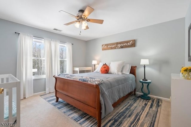 bedroom with carpet, visible vents, ceiling fan, and baseboards