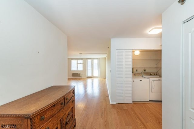 corridor with washing machine and dryer and light hardwood / wood-style floors