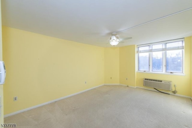 spare room featuring light carpet, a wall mounted AC, and ceiling fan