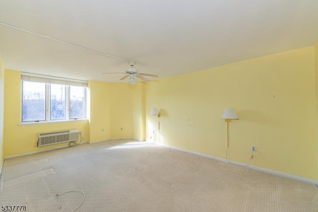 carpeted empty room with a wall mounted air conditioner and ceiling fan