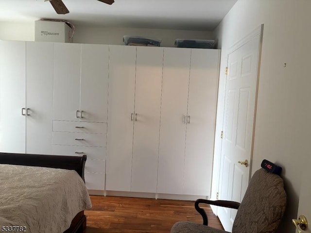 bedroom with dark wood-type flooring and ceiling fan