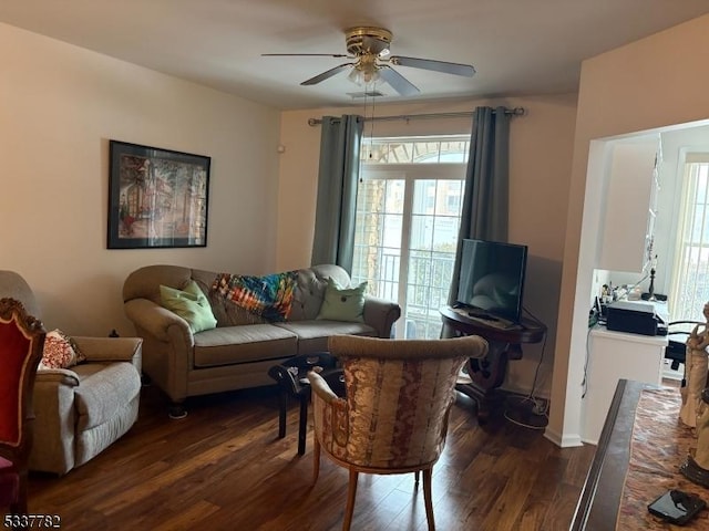 living room with dark hardwood / wood-style floors and ceiling fan