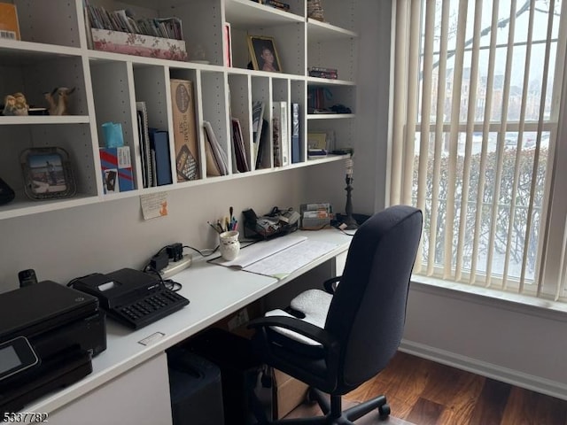 office area with dark hardwood / wood-style flooring and built in desk