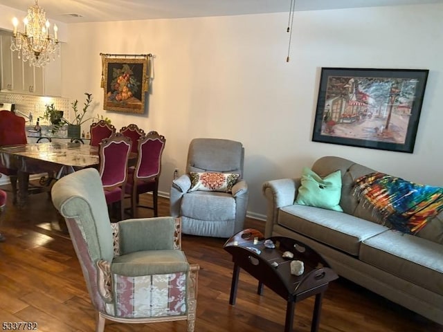 living room featuring dark hardwood / wood-style floors and a chandelier