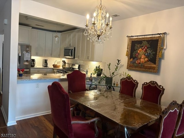 dining space with a notable chandelier and dark wood-type flooring