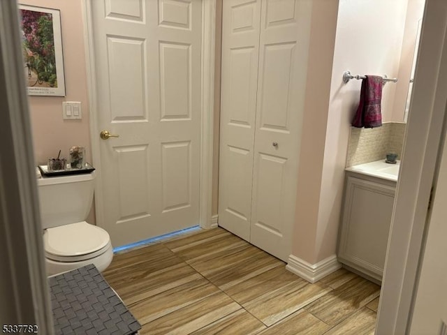 bathroom with vanity, hardwood / wood-style floors, and toilet