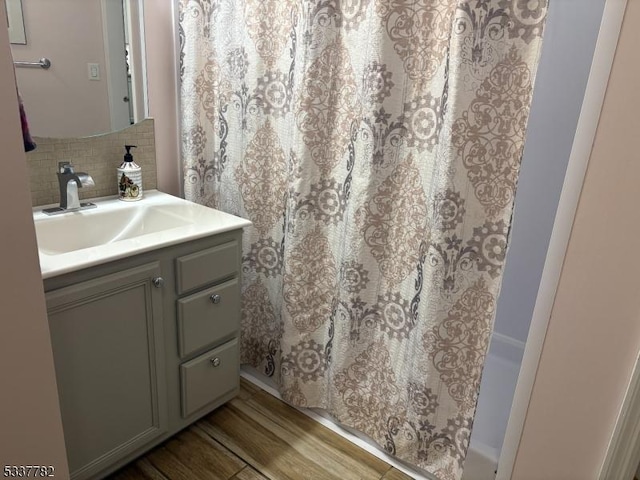 bathroom featuring tasteful backsplash, vanity, and hardwood / wood-style floors