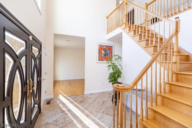 entryway with a towering ceiling