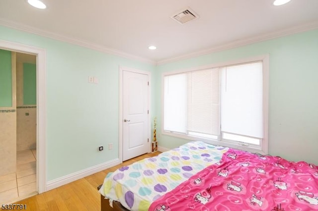 bedroom with crown molding and hardwood / wood-style flooring