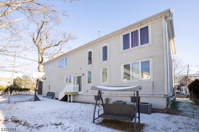 snow covered property featuring central air condition unit