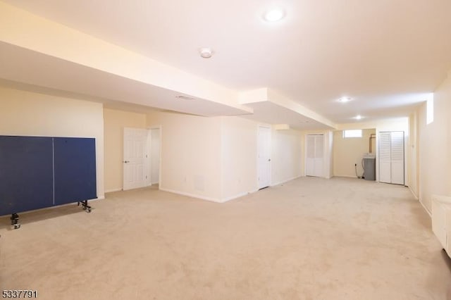 basement featuring light carpet