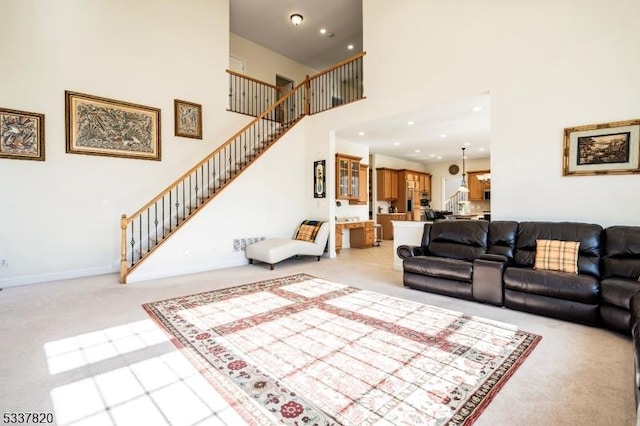 living room featuring a high ceiling and light carpet