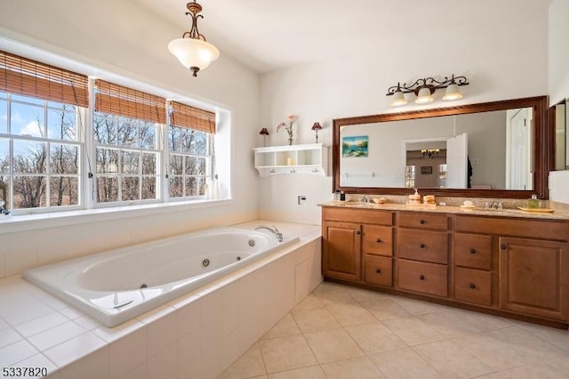 bathroom with vanity, tiled tub, and tile patterned flooring