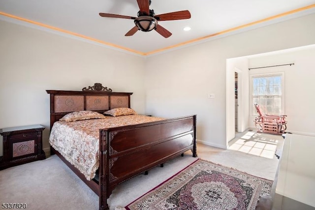 carpeted bedroom with crown molding and ceiling fan