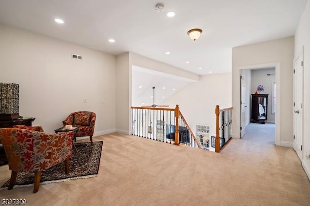 living area featuring light colored carpet and vaulted ceiling