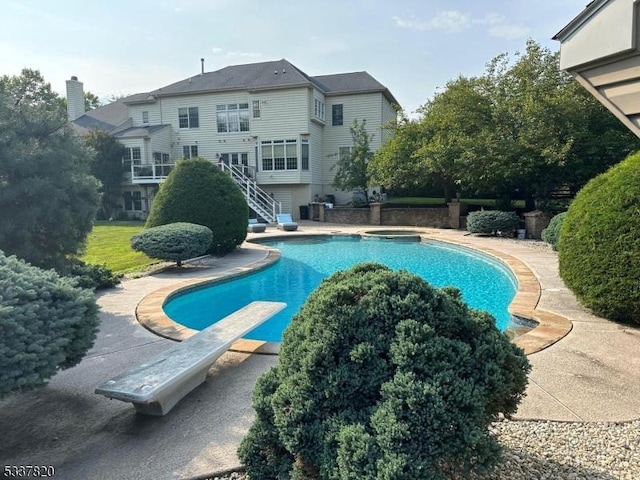 view of pool featuring a diving board