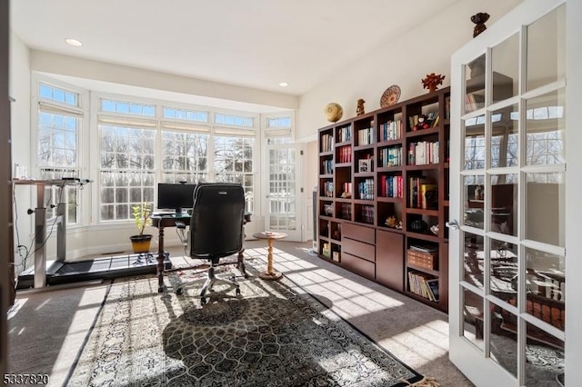 carpeted home office featuring french doors