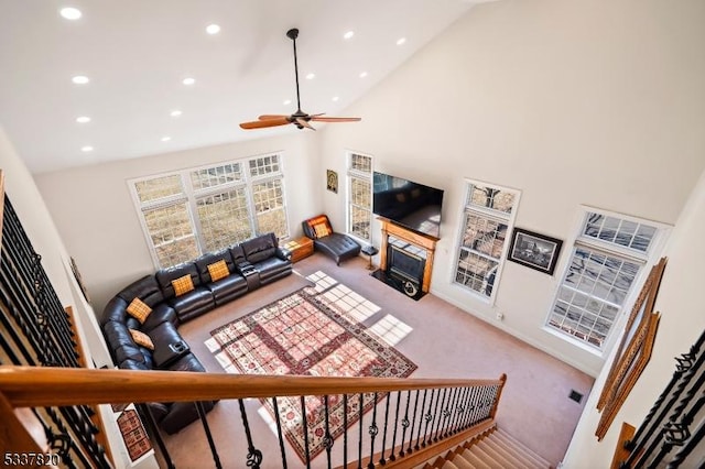 living room featuring high vaulted ceiling, ceiling fan, and carpet flooring