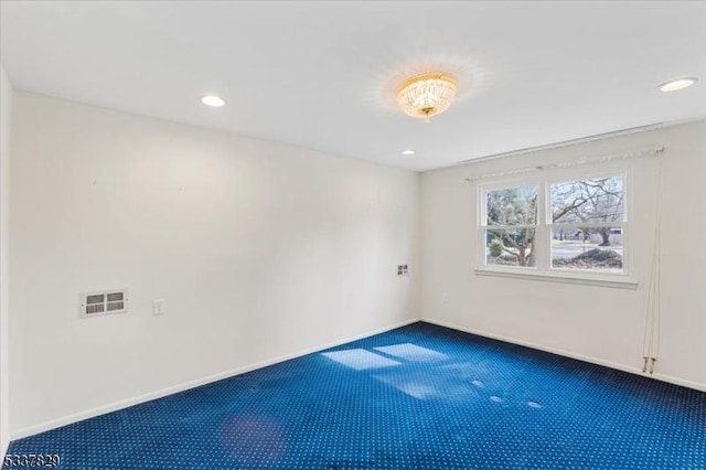 spare room featuring baseboards, visible vents, dark colored carpet, and recessed lighting