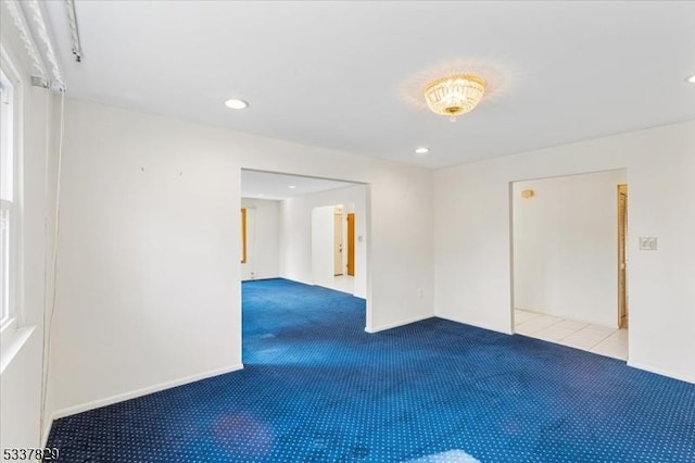 carpeted empty room with baseboards and recessed lighting