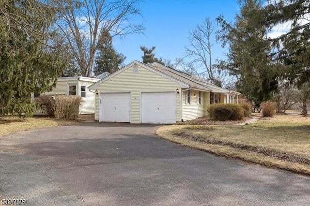 view of front of home featuring aphalt driveway and an attached garage