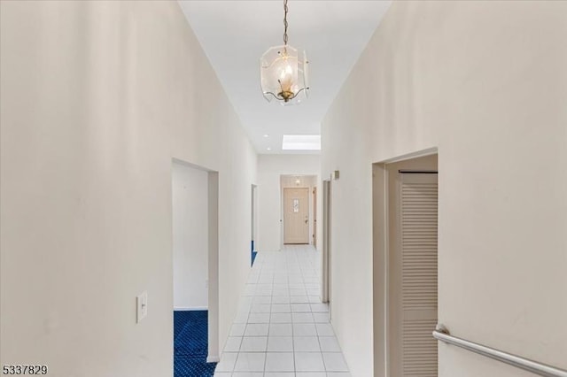 hall with light tile patterned floors