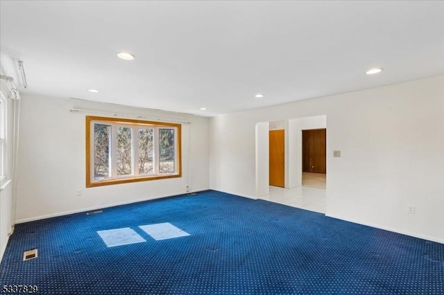 carpeted empty room featuring visible vents and recessed lighting