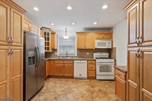 kitchen featuring white appliances, recessed lighting, a sink, glass insert cabinets, and backsplash