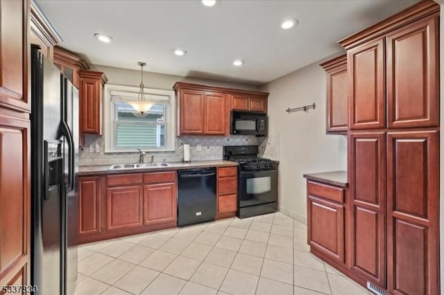 kitchen with black appliances, pendant lighting, backsplash, and a sink