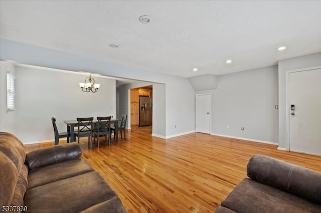 living room featuring recessed lighting, a chandelier, baseboards, and light wood-style flooring