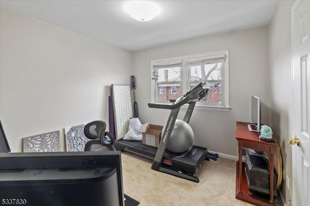 workout area with baseboards and carpet floors