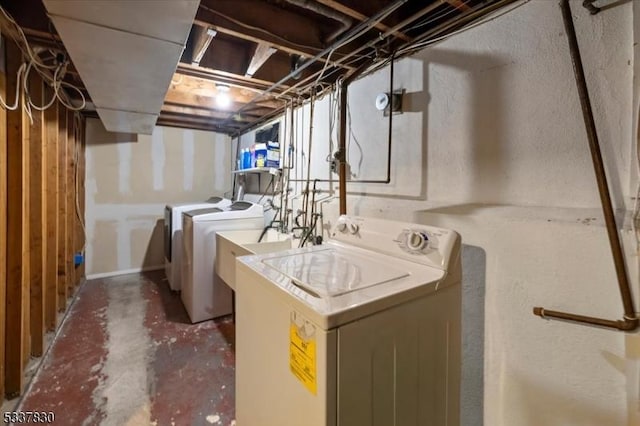 laundry room featuring separate washer and dryer and laundry area