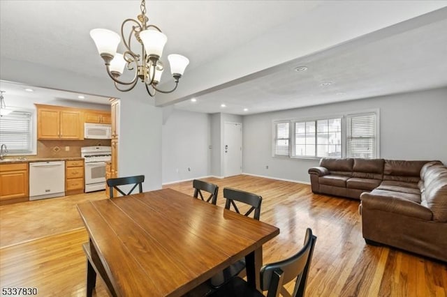 dining space with a notable chandelier, recessed lighting, baseboards, and light wood finished floors