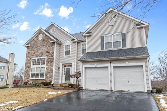 traditional home with aphalt driveway, stone siding, roof with shingles, and a garage